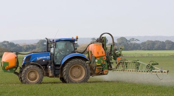 Tractor spraying a crop